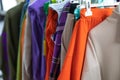 Juicy and bright women's clothing in casual style hangs on the railing on the hanger