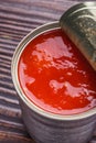 Juicy canned tomatoes on wooden rustic background