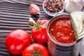 Juicy canned tomatoes on wooden rustic background