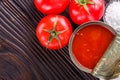 Juicy canned tomatoes on wooden rustic background