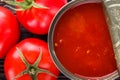 Juicy canned tomatoes on wooden rustic background