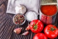 Juicy canned tomatoes on wooden rustic background