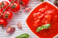 Juicy canned tomatoes on wooden rustic background