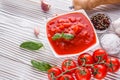 Juicy canned tomatoes on wooden rustic background