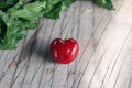 Juicy cherry berry near green mint leaves on vintage wooden background