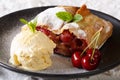 Juicy cherry strudel with vanilla ice cream and mint closeup. ho Royalty Free Stock Photo