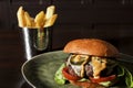 Juicy classic beefburger with french fries bucket Royalty Free Stock Photo