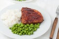 Juicy cooked steaks with green peas
