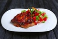 Juicy and crispy chopped pork fried on grill with fresh vegetables red cabbage, tomato, cucumber, carrot and bell pepper Royalty Free Stock Photo