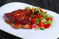 Juicy and crispy chopped pork fried on grill with fresh vegetables red cabbage, tomato, cucumber, carrot and bell pepper Royalty Free Stock Photo