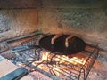 juicy cuts of meat are fried in a cast iron pan on burning coals in a barbecue oven