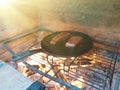 juicy cuts of meat are fried in a cast iron pan on burning coals in a barbecue oven