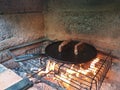 juicy cuts of meat are fried in a cast iron pan on burning coals in a barbecue oven