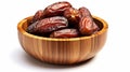 Juicy dates in a wooden bowl isolated on white background