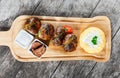 Juicy delicious meat cutlets and hominy ,Corn porridge Polenta, with goat cheese on cutting board on wooden background Royalty Free Stock Photo