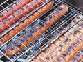 Juicy delicious sausages on the grill are fried in the grill on coals Royalty Free Stock Photo