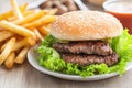 Juicy Double Cheeseburger with Lettuce and Fries on a Plate Royalty Free Stock Photo