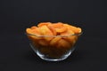 Juicy dried apricots in a glass bowl. Dried apricot fruit halves without a stone