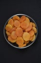 Juicy dried apricots in a glass bowl. Dried apricot fruit halves without a stone