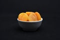 Juicy dried apricots in a white ceramic bowl. Dried apricot fruit halves without a stone