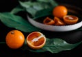 Juicy fiery oranges decorated with green leaves