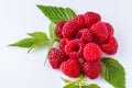 Juicy fresh natural raspberries on white acrylic background