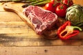 Juicy fresh piece of marbled beef steak with vegetables for grilling. Culinary background, recipe book, delicious food, Cooking Royalty Free Stock Photo