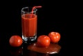 Juicy fresh red tomatoes in juice on a black dark background Royalty Free Stock Photo