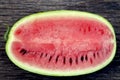 Juicy fresh red watermelon on the table. Watermelon sliced into pieces on a wooden texture background. Royalty Free Stock Photo