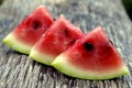 Juicy fresh red watermelon on the table. Watermelon sliced into pieces on a wooden texture background. Royalty Free Stock Photo