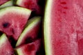 Juicy fresh red watermelon on the table. Watermelon sliced into pieces on a wooden texture background. Royalty Free Stock Photo