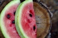 Juicy fresh red watermelon on the table. Watermelon sliced into pieces on a wooden texture background. Royalty Free Stock Photo