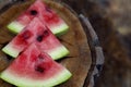 Juicy fresh red watermelon on the table. Watermelon sliced into pieces on a wooden texture background. Royalty Free Stock Photo