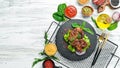 Juicy fried pork steak with spices on a black stone plate. Royalty Free Stock Photo