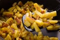 Juicy fried potatoes in a frying pan, homemade roasted potatoes with a crispy crust close up. Royalty Free Stock Photo