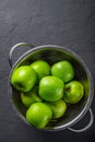 Juicy green apple in stainless steel colander on Dark grey black slate background Royalty Free Stock Photo