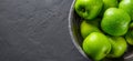 Juicy green apple in stainless steel colander on Dark grey black slate background Royalty Free Stock Photo