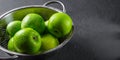 Juicy green apple in stainless steel colander on Dark grey black slate background Royalty Free Stock Photo