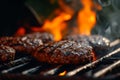 Juicy Grilled BBQ Burger Patties with Flames in Background - Perfect for Cookout Menus and Grill Master Blogs. Royalty Free Stock Photo