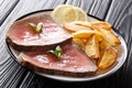 Juicy grilled beef steak with roasted potatoes and lemon close-up on a plate. horizontal Royalty Free Stock Photo