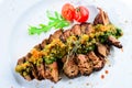 Juicy grilled beef steak with sauce pesto in a white plate, top Royalty Free Stock Photo