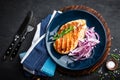 Juicy grilled chicken meat, fillet with fresh marinated onion on plate. Black background, top view, closeup