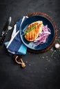 Juicy grilled chicken meat, fillet with fresh marinated onion on plate. Black background, top view, closeup