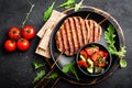 Juicy grilled chicken meat lula kebab on skewers with fresh vegetable salad on black background Royalty Free Stock Photo