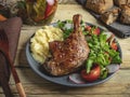 Juicy grilled duck leg with tomato, herbs ,mashed potatoes in a plate