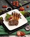 Juicy grilled meat steak with vegetables. Delicious tender meat Medallion fried on wire rack. Exquisitely served lunch