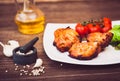 Juicy grilled pork fillet served with cherry tomatoes branch Royalty Free Stock Photo