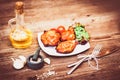 Juicy grilled pork fillet served with cherry tomatoes branch and lettuce on white plate. Background: wooden boards. Close-up. Royalty Free Stock Photo