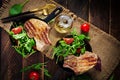 Juicy grilled pork steak with herbs on bone on wooden background. Royalty Free Stock Photo