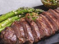 Juicy, grilled, sliced beef steak, with roasted asparagus, close up, sauce Royalty Free Stock Photo